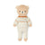 Knitted teddy bear wearing a patterned sweater on a white background
