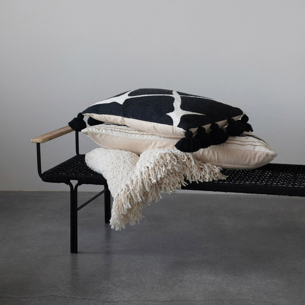 Cream colored cotton blend bouclé throw with fringe detailing draped over a black metal bench, with other similar throws in the background.

Boucle fringe throw blanket, boutique home décor from Ella Collective Raleigh.